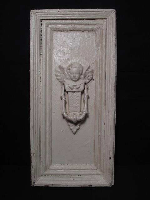 VICTORIAN WOOD PANEL DOOR KNOCKER: Victorian painted wood panel with attached door knocker in the form of a cherub. Painted white, but has paint chipping off in some areas. Overall good condition, wear from age, dings, dents and paint 