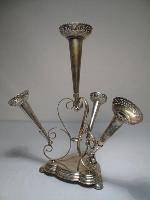 VICTORIAN SILVER PLATED EPERGNE: Victorian silver plated floral epergne. Reticulated rims. Removable flutes. Engraved design on base. Good condition, tarnishing from age, minor dents, scratches, see images. Measures 17" tall x 14.5" 