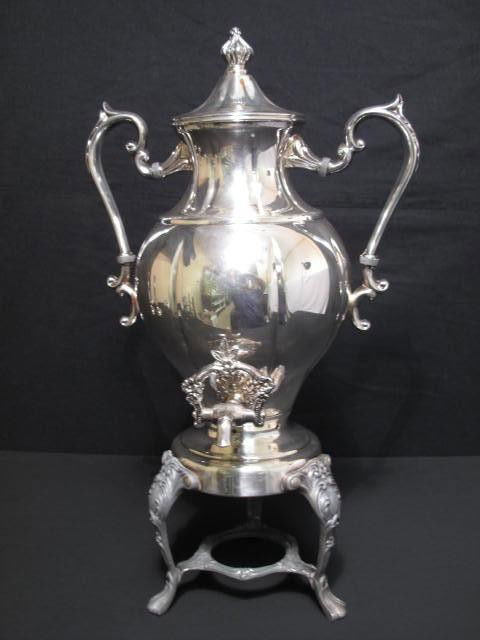 VICTORIAN SILVERPLATE COFFEE MAKER: Victorian silverplate coffee maker. On pedestal tripod. Lidded, with handles and adjustable spout 3/4 of the way down the pot. Not marked. Condition: one of the handles is detached at the bottom, see