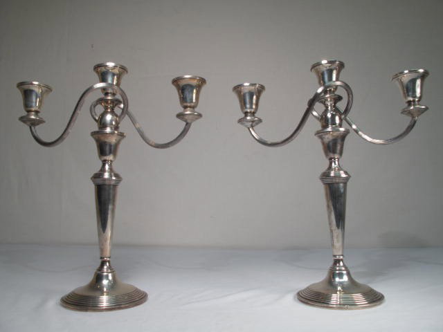 PAIR STERLING THREE ARM CANDELABRAS: Pair of Sterling silver candelabras. Three candle holders with serpentine design. Marked "Crown Sterling weighted" on bottom. Good condition, minor scuffs/ scratches, etc, see images. Each measures 12