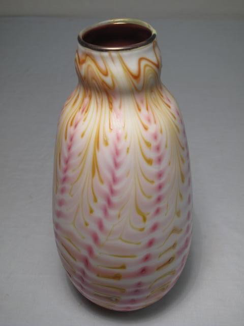 CHARLES LOTTON ART GLASS VASE: An early 20th century cased art glass vase with swirled design of white/pink/yellow and a silver/pink iridescence. Signed "Charles Lotton" and dated 1978. Measures 10" tall. Condition: minor flaw to r