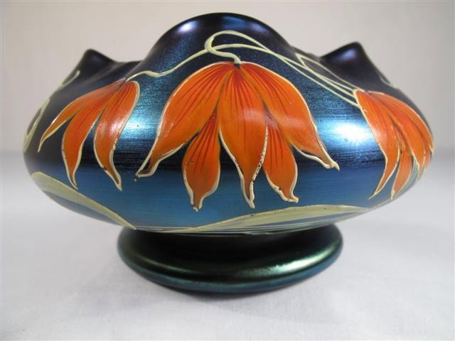 POSCHINGER JUGENDSTIL ENAMELED GLASS VASE: Ferdinand von Poschinger deep blue art glass vase with purple iridescence and enameled floral design. Marked, N (0 or 8?) L 60. Measures 5 3/4" wide. Condition good. Shipping weight 1.2 lbs.