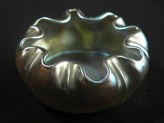 TIFFANY STUDIOS FAVRILE GLASS MASTER SALT CELLAR: A Tiffany Studios Favrile glass salt cellar with ruffled rim. Condition: good. Etched on bottom "L. C. T.". Measures 2.3" across. Shipping weight .1 lbs.
