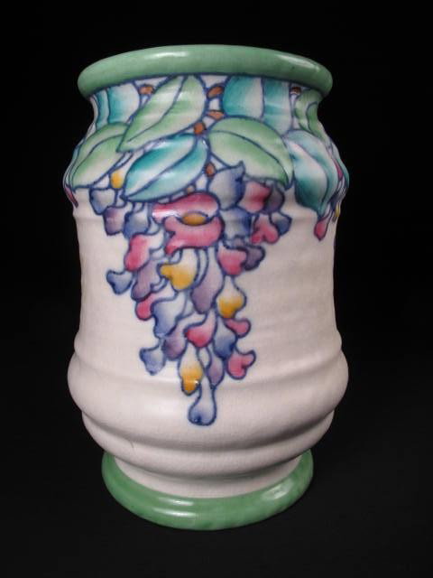 CHARLOTTE RHEAD CROWN DUCAL ART POTTERY VASE: A Crown Ducal art pottery vase by Charlotte Rhead with colorful Wisteria type floral design. Artist signed on base. Measures 7" tall. Condition good. Shipping weight 1.1 lbs.