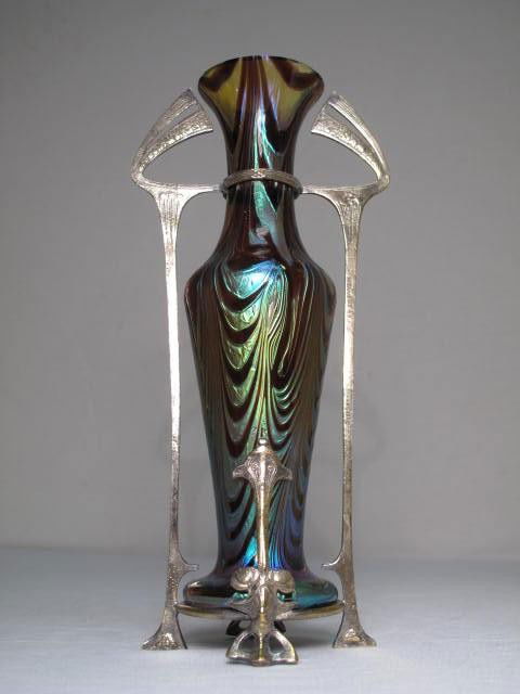 LOETZ SECESSIONIST METAL MOUNTED ART GLASS VASE: Loetz Secessionist art glass vase with elaborate silver on copper mount. Measures 10" tall. Unsigned. Condition good. Shipping weight 1 lbs.