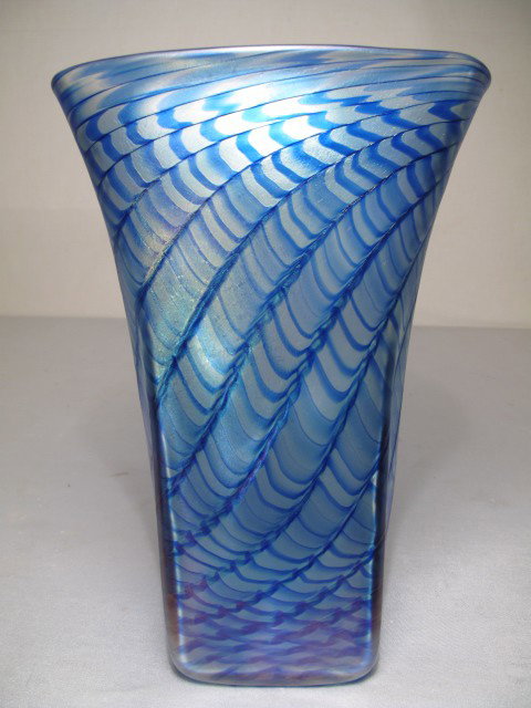 J. MOREL ZELLIQUE STUDIO LG BLUE ART GLASS VASE: Modern Zellique studio art glass vase signed "J.M." (Joe Morel) and dated 1991. Rectangular form with wavy blue decoration with gold iridescence. Height: 11 3/4". Width: 7 1/2" at mouth. Depth: 5 1/4"
