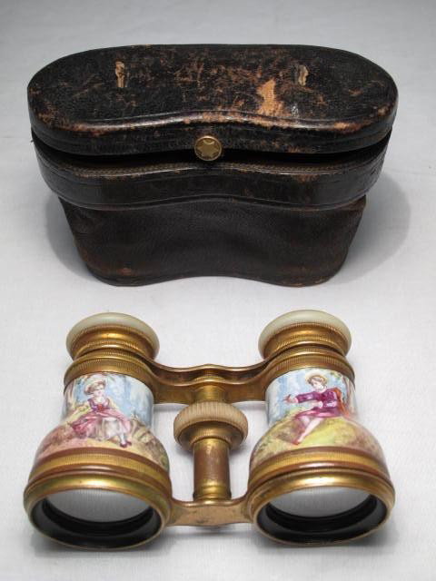 TIFFANY & CO. ENAMELED OPERA GLASSES: Tiffany & co, New York enameled opera glasses with Mother of Pearl attachment, ormolu bronze and original leather case. Measures 4" x 2 1/2" tall, case measures 4 3/4" x 3". Condition good with some l