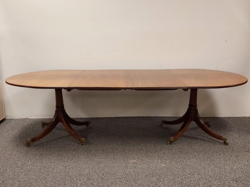 DUNCAN PHYFE STYLE CHERRYWOOD DINING TABLE: Duncan Phyfe style cherrywood dining table measuring 28.5" tall x 44" wide and a total of 104" long. One of the 22" leafs can be removed to shorten the table. Condition: fading to parts of the top sur