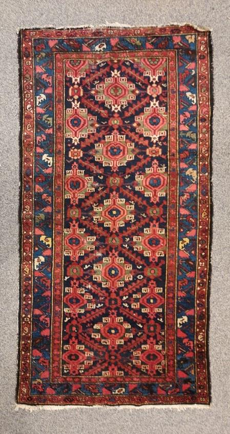 ANTIQUE HAMADAN HAND KNOTTED PERSIAN RUG 3' X 7': Antique Hamadan hand knotted Persian wool rug measuring 3'5" x 6'8". Condition: some low spots on pile with foundation showing in areas, appear to have some re-coloring, fringes worn, see images. Weig