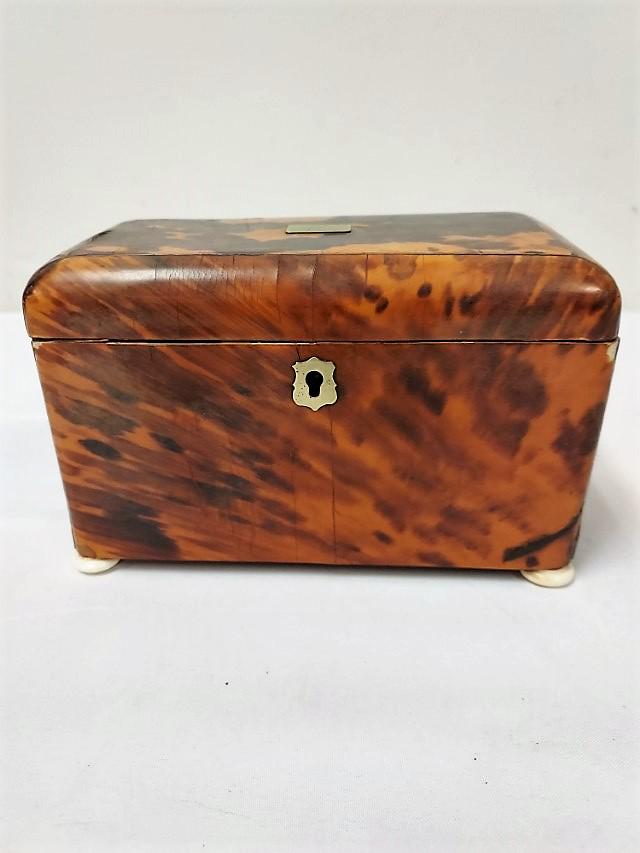 ANTIQUE TORTOISE SHELL & BONE TEA CADDY: Antique Tortoiseshell tea caddy with carved bone feet. Measures 4.75" x 7.5" long and 4.25" deep. Condition: normal signs of wear and use/age, scattered small losses to veneer, see images. Weight: 1.3