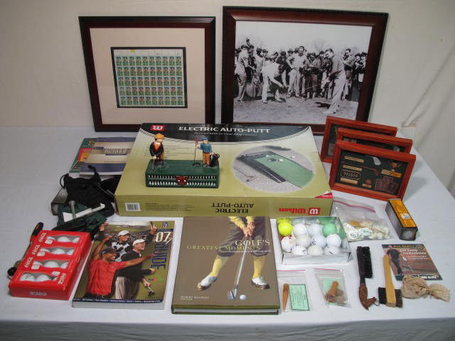 LOT ASSORTED GOLF COLLECTIBLES: Large lot of assorted golf collectibles. Includes an electric auto-putt machine, a metal golf bank replica, stamp framed display, various golf memorabilia displays, and much more, see images. Conditio
