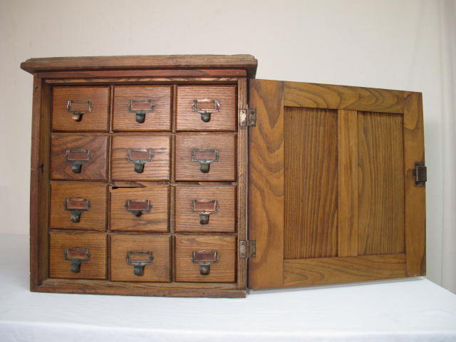 KEYSTONE VIEW SLIDE CARD FILING CABINET: Antique Keystone View slide card filing cabinet. Locks on front. 12 sliding drawers inside. Plaque on front of door reads "Keystone View Company". Condition: wear and age as expected, some cracks to w