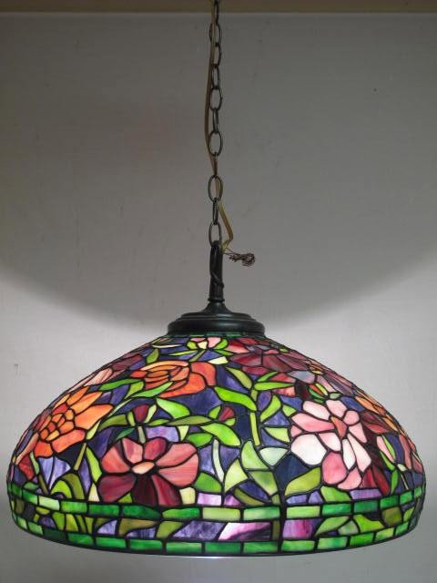 DALE TIFFANY HANGING CHANDELIER LAMP: Dale Tiffany hanging chandelier. Floral pattern, colors of green, pink, red blue, etc. Metal label inside shade reads "Dale Tiffany Inc.". Three sockets for bulbs. Condition: good, needs rewiring, see