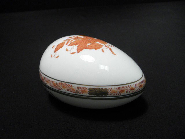 HEREND PORCELAIN HAND PAINTED EGG BOX: Herend porcelain hand painted egg box. Orange floral pattern, marked on base "Herend Hungary 6052/AOG". Measures 2.75" tall x 4.5" long. Shipping weight .4 lbs.