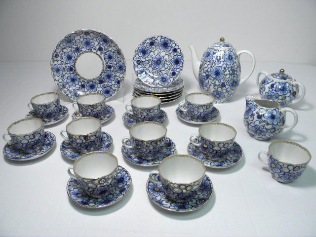 LOMONOSOV RUSSIAN PORCELAIN GILT TEA SET 31 PCS: Lomonosov Russian porcelain gilt tea set. Blue and gilt floral pattern. Marked on base "Made in Russia" with Lomonosov makers mark. Includes (11) 3.5" teacups, (1) 8.6" plate, (1) 7.5" tall teapot, (6