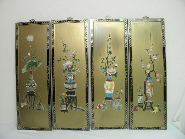 A CHINESE HARD STONE FOUR PANEL SCREEN: A Chinese screen of wood panels with hard stone decorations, gilt and black paint. Applied carved hard stone decorations depict floral arrangements in Famille Rose vases. Each panel measures 36" tall 
