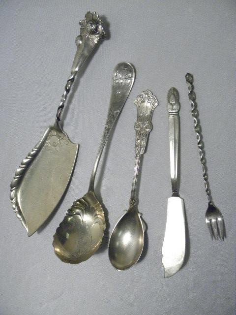 FIVE STERLING SILVER SERVING ITEMS: 8.39 TROY OZ: Assorted sterling silver serving utensils. Includes 10.25" cake server, small 6" fork, 7" master butter knife, 7" sugar spoon, and 8" serving spoon. Total weight: 8.39 troy oz. Three pieces engraved. 