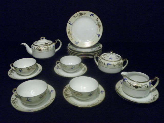 NORITAKE JAPANESE PORCELAIN TEA SET 19 PCS: Noritake Japanese porcelain tea set. Gilt decorated with hand painted blue birds. 19 pieces. Includes four 4.5" cups, six 7.5" plates, six 5.5"saucers, one 8.5" teapot (handle to spout), one 6" lidded