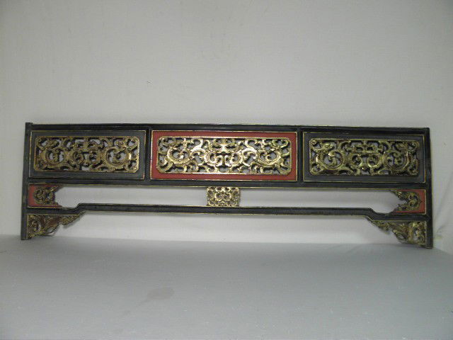 CHINESE RED & BLACK LACQUER GILT WOOD CARVING: Chinese red and black lacquer gilt wood carving. Intricately carved scroll details. Previously part of an Opium bed. Condition: some loss of lacquer and gilt at corners and side edges, heavy signs of