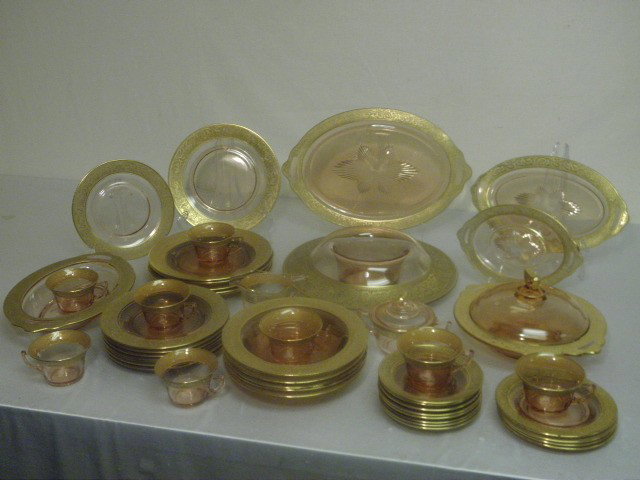 CAMBRIDGE GILT PINK DEPRESSION GLASS DINNERWARE 47: Cambridge gilt pink depression glass dinnerware. 47 pieces total. Detailed gilt rims. Includes (1) 16" x10.5" dish, (1) 12" oval dish, (1) 12" casserole dish, (1) 13" centerpiece bowl, (8) 4.25" cups,
