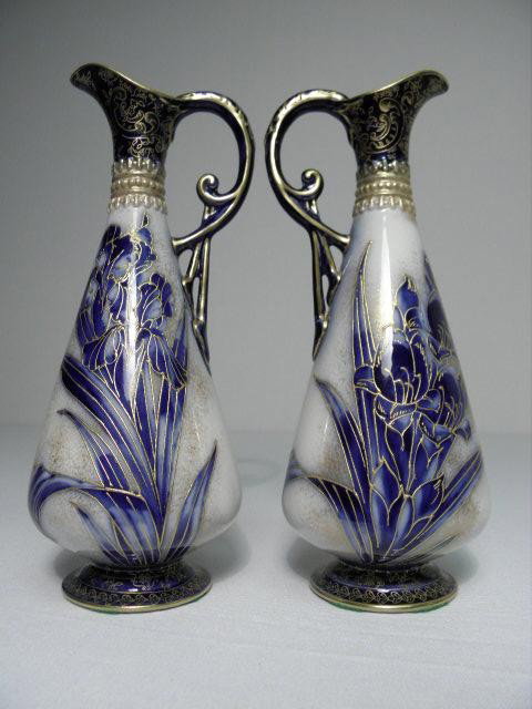 PAIR DOULTON BURSLEM HAND PAINTED PORCELAIN EWERS: Pair of Doulton Burslem hand painted porcelain ewers. Flow blue with gilt hand painted floral designs. Each marked on base "Doulton Burslem RdNo 160951". Condition: crazing to glaze, wear to gilt pain