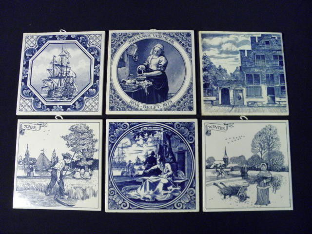 SIX DELFT BLUE & WHITE TILES: Six Delft blue and white tiles. Includes a tile with a farm worker marked "Zomer", a tile showing a sail maker marked "De Zeifemaaker", a tile depicting a clipper ship, a tile showing a woman marked "