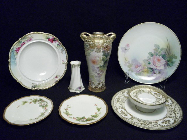 ASSORTED NIPPON PORCELAIN 7 PCS: Assorted pieces of Nippon porcelain. 7 pieces. Includes floral and gilt decorated handled vase, a small floral bud vase, a gilt decorated two tiered serving plate, a large floral plate, soup bowl, and