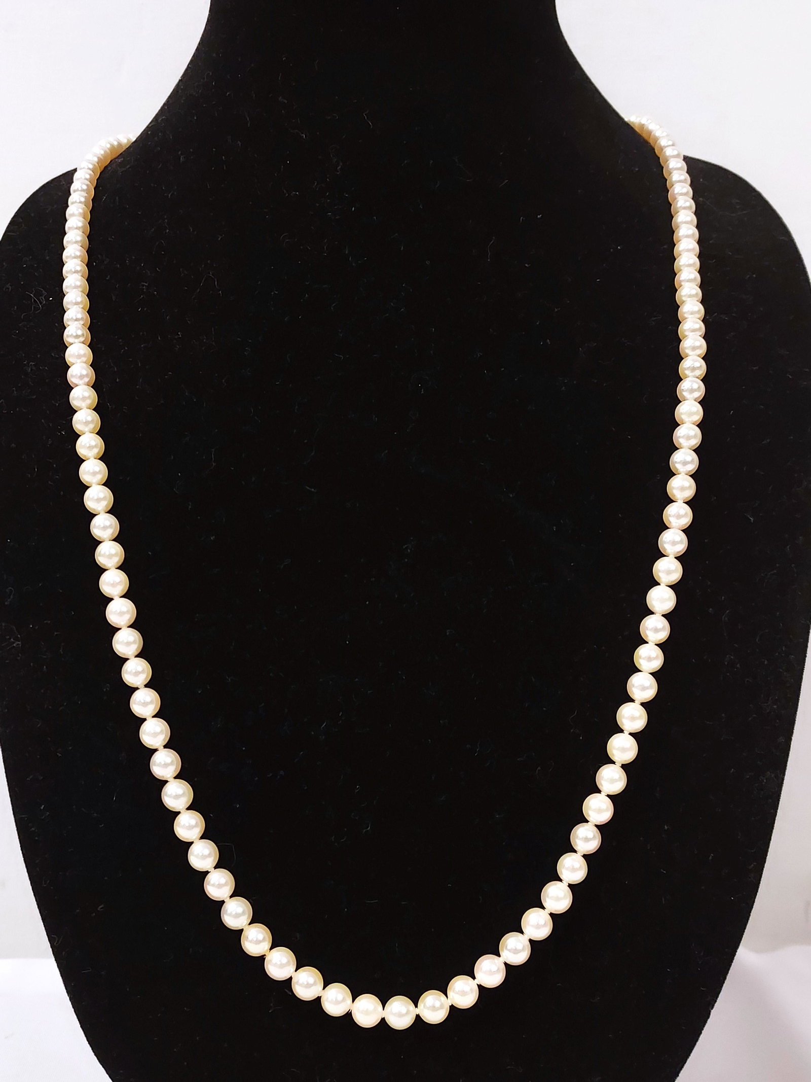 ONE 30" PEARL NECKLACE (10): A pearl necklace measuring 30" long with uniform cultured cream pearls each measuring 6.2mm. Clasp stamped 14kt.Total weight 24.4dwt. Condition: good