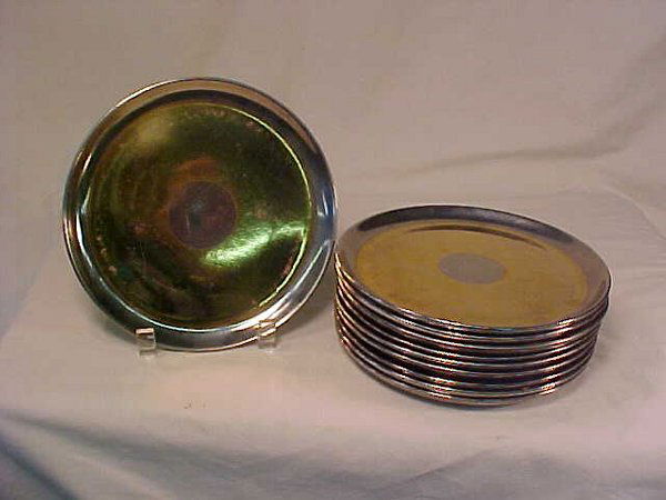 RUSSEL WRIGHT LUSTER POTTERY PLATES 6": RUSSEL WRIGHT LUSTER POTTERY PLATES 6" Ten gold and silver metallic pottery plates. Each measures 6" wide. Silvered rim, wide gold band, center silver circle over pink pottery bases. Reverse marked, "