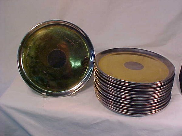 RUSSEL WRIGHT LUSTER POTTERY PLATES: RUSSEL WRIGHT LUSTER POTTERY PLATES Thirteen gold and silver metallic pottery plates. Each measures 10" wide. Silvered rim, wide gold band, center silver circle over pink pottery base. Reverse marked,