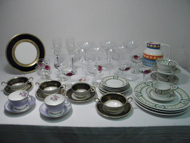 ASSORTED CRYSTAL STEMWARE & PORCELAIN DINNERWARE ET: Large lot of assorted cut crystal stems and fine porcelain dinnerware. Total of 47 pieces. Includes a pair of Mikasa crystal candlesticks, a pair of clear and black glass candlesticks, a partial set o
