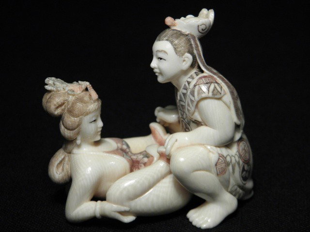 JAPANESE CARVED IVORY EROTIC NETSUKE GROUP: Japanese carved ivory erotic netsuke group. Depicts a man and woman in a sexual act. Intricately carved and colored. Signed on base of man's foot. Condition: good, no chips or cracks, see images. Man 