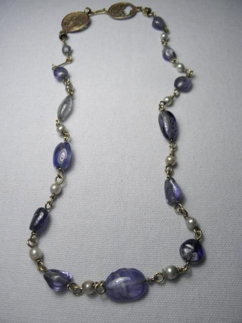 ANCIENT EGYPTIAN GOLD PEARL & SAPPHIRE NECKLACE: Ancient Egyptian gold, pearl, and sapphire necklace in the etruscan style. Embossed gold medallions with hooks for clasps. Series of gold links strung alternately with baroque pearls and thirteen roug