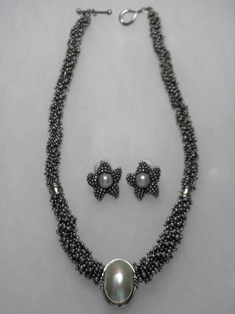 MICHAEL DAWKINS NECKLACE & STEPHEN DWECK EARRINGS: Michael Dawkins Sterling Silver necklace and a pair of Stephen Dweck Sterling silver earrings. Necklace is strung with graduated star shaped beads, with a mother of pearl pendant on the end. Stamped "