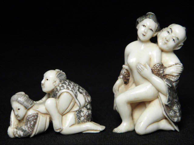 TWO JAPANESE CARVED IVORY EROTIC NETSUKE: Two Japanese carved ivory erotic netsuke. One is signed on foot and depicts a man and a woman upright, and the other is possibly signed on man's sleeve, and depicts a man and a woman laying down. Cond