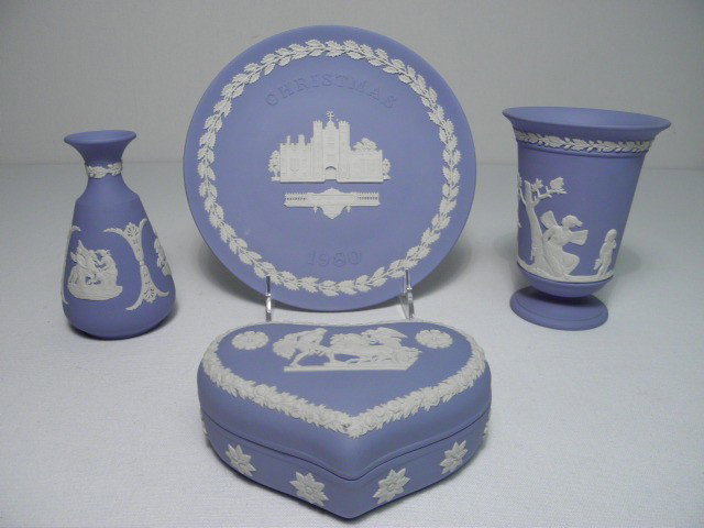 FOUR PIECES WEDGEWOOD BLUE JASPERWARE PORCELAIN: Four pieces of Wedgwood blue Jasperware porcelain. Includes a small bottle or vase with fluted rim, a footed vase, a heart shaped box, and a "Christmas 1980" plate. All pieces marked on base. Conditio