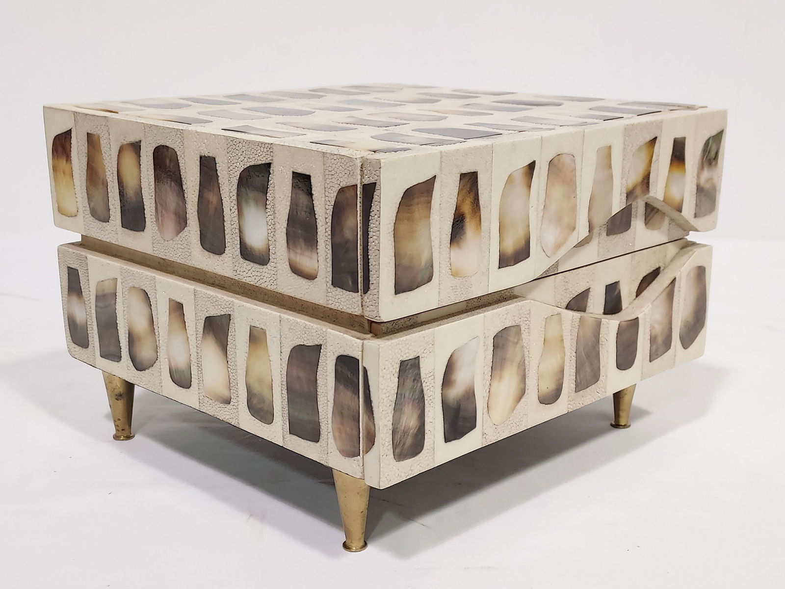 R & Y AUGOUSTI SHELL INLAID SHAGREEN JEWELRY BOX: Ria & Youri Augousti shell inlaid shagreen jewelry box with brass legs. Measures 7.5" tall x 10.5" wide and 10" deep. Signed on the base. Condition: very light expected tarnishing to brass legs, see i