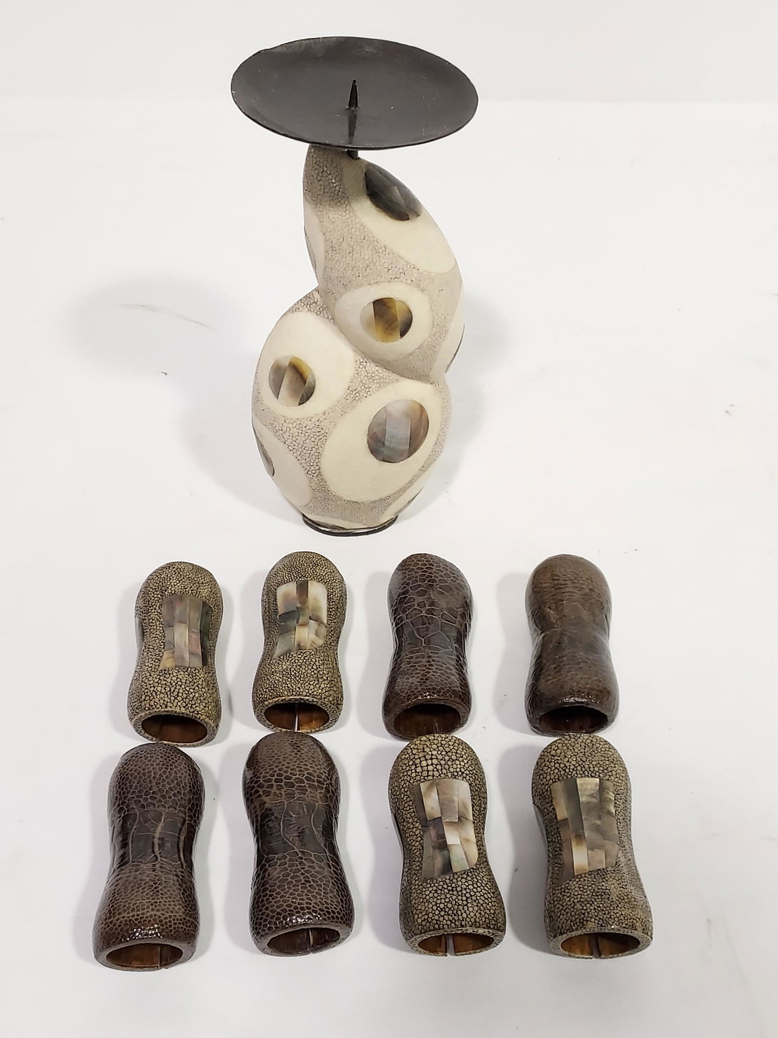 R & Y AUGOUSTI NAPKIN RINGS & PRICKET CANDLESTICK: Ria & Youri Augousti napkin rings (four shagreen / mother of pearl and four reptile leather, 3.6" long), and a shagreen / mother of pearl pricket candlestick (9.5 " tall). Condition: good, no signs of