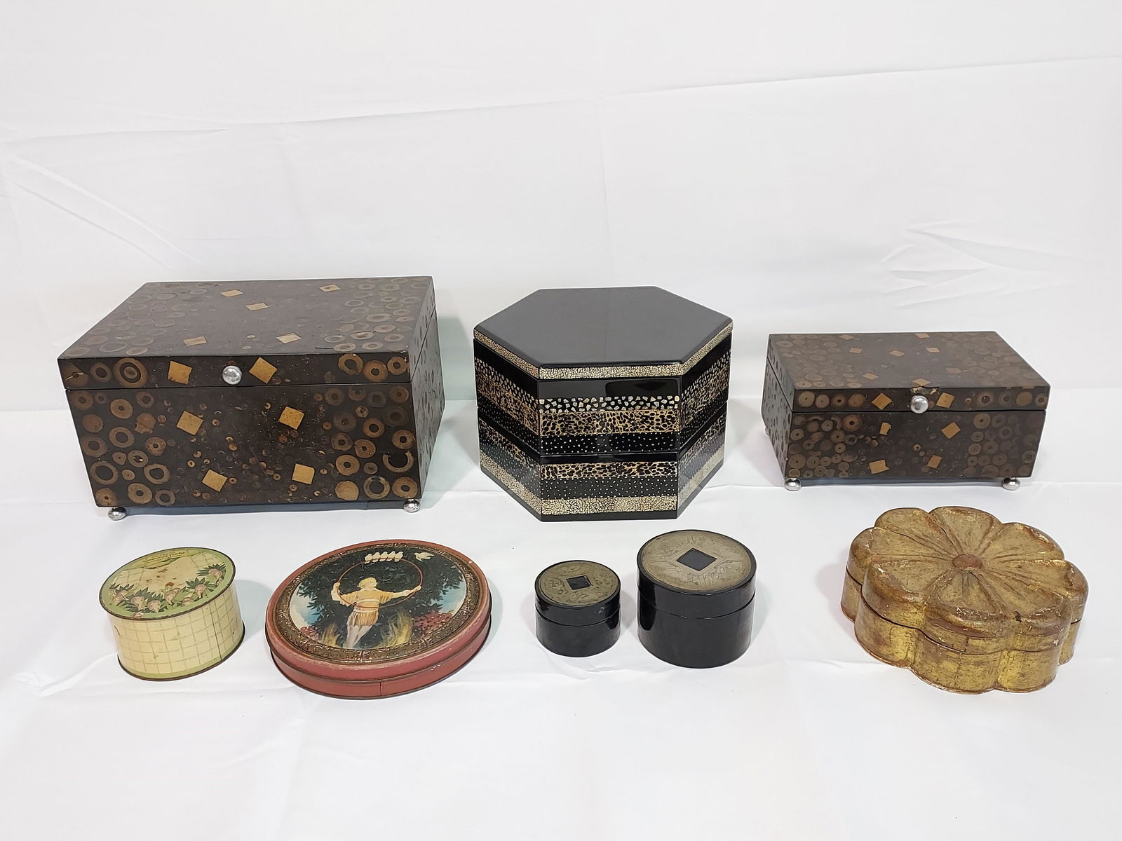 EIGHT DECORATIVE BOXES: LACQUER, RESIN, ETC.: Lot of eight decorative boxes. Includes a 7" tall x 9.5" wide multi layer box with inlaid stone pattern, a 7.5" tall resin box with inlaid circles, a matching 5" inlaid circles box, and five smaller r