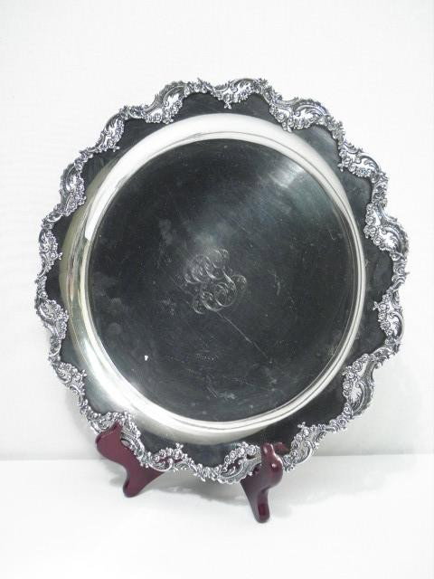 THEODORE B. STARR STERLING SILVER SALVER: Theodore B. Starr sterling silver salver. Rococo style pierced silver border with foliate and floral swags, monogrammed in center. Stamped on base with Theodore B Starr maker's mark and "Theodore B. S