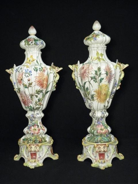 PAIR NOVE ITALIAN PORCELAIN FLORAL LIDDED URNS: Pair of 19th century very large Nove Italian faience lidded urns. Three part ballister style design with a floral painted pattern. Each sits upon a four footed base and has a lid at the top. Bases sho