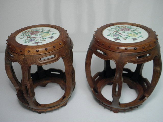 PAIR CHINESE TEAK & PORCELAIN GARDEN STOOLS: Pair Chinese teak & porcelain garden stools or seats. Circular porcelain seat built into frame and hand painted with butterflies, birds, and flowers. Open five spindle design sitting upon five carved 
