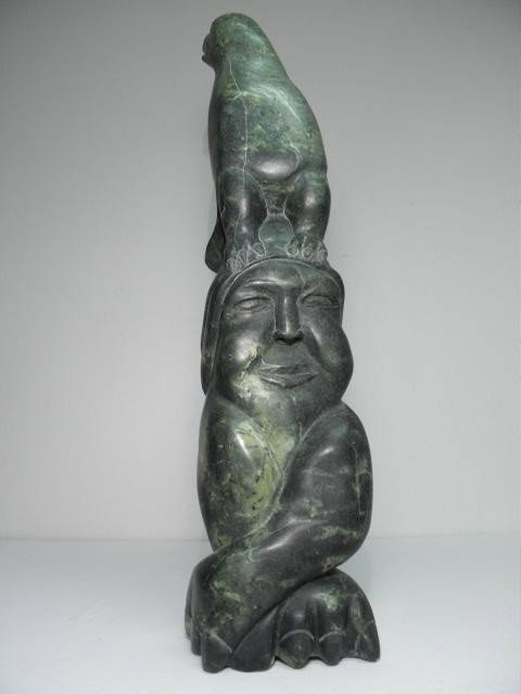KAKA ASHOONA CARVED INUIT STONE TOTEM SCULPTURE: Kaka (Qaqaq) Ashoona (Canadian, 1928-1996) carved stone inuit totem sculpture. Cape Dorset, circa 1980. Depicts a woman with a bird spirit on her head. Signed on base "KAKA". Condition: very small chi