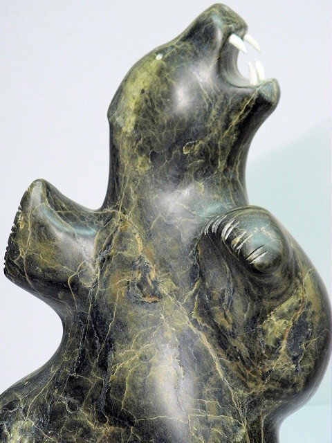 PAUTA SAILA "DANCING BEAR" CARVED STONE INUIT SCUL: Pauta Saila (Canadian, 1916-2009) carved stone Inuit sculpture. Cape Dorset, a large example of Pauta's most famous subject: the "Dancing Polar Bear" with carved bone teeth. Signed indistinctly on the