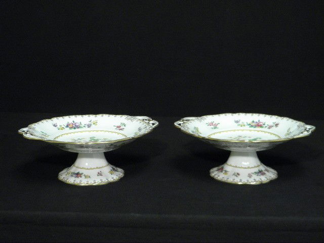 PAIR COPELAND SPODE "PEPLOW" PORCELAIN COMPOTES: Pair Copeland Spode porcelain compotes in the "Peplow" pattern. Manufactured for Harrod's Limited. Hand colored, with gilt highlights, and handled on each side. Marked on base "Manufactured for Harrod