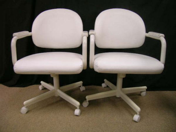 PR CHROMCRAFT CASTORED SWIVEL VINYL ARM CHAIRS: Lot 1264: PR CHROMCRAFT CASTORED SWIVEL VINYL ARM CHAIRS - Each measures 33 3/4" high x 22 3/4" wide x 23 1/2" deep. Seat height is 18". Some paint wear to arm rests. Good condition.
