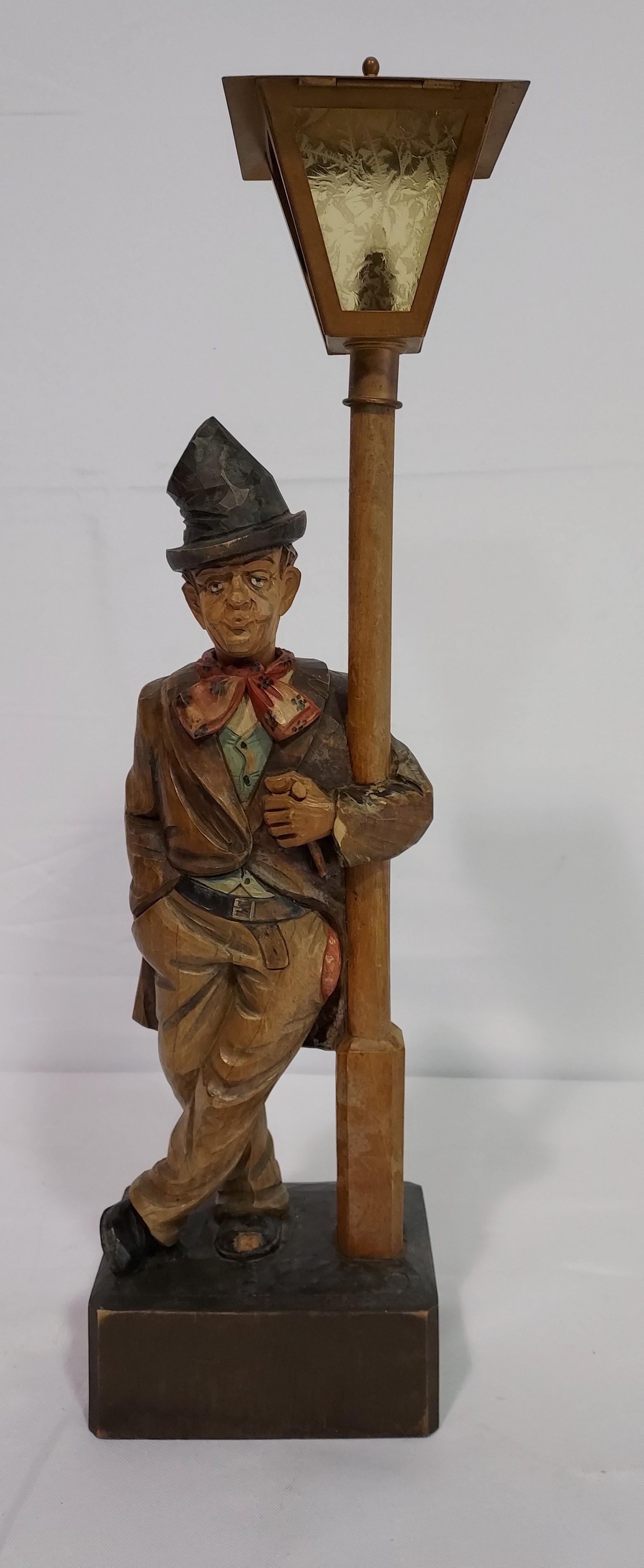 VINTAGE KARL GRIESBAUM CARVED WOOD AUTOMATON: Vintage Karl Griesbaum carved wood automaton measuring a total of 19.1" tall x 5.5" wide. Man with pipe is supposed to turn his head, whistle, and light the lamp post. Condition: this automaton runs, 