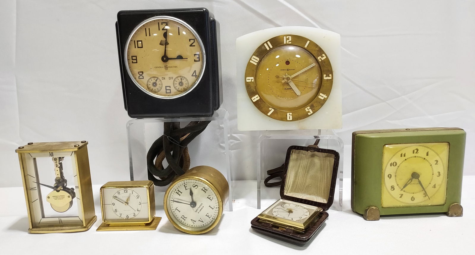 7 VINTAGE & ANTIQUE CLOCKS: HAMILTON, HERSCHED: Lot of seven vintage and antique clocks: Includes a Hamilton 7 jewel, 8 day skeleton desk clock, a small Herschede alarm clock, a GE Onyx alarm clock model 7H104, a GE Telechrom alarm clock, a Westclo