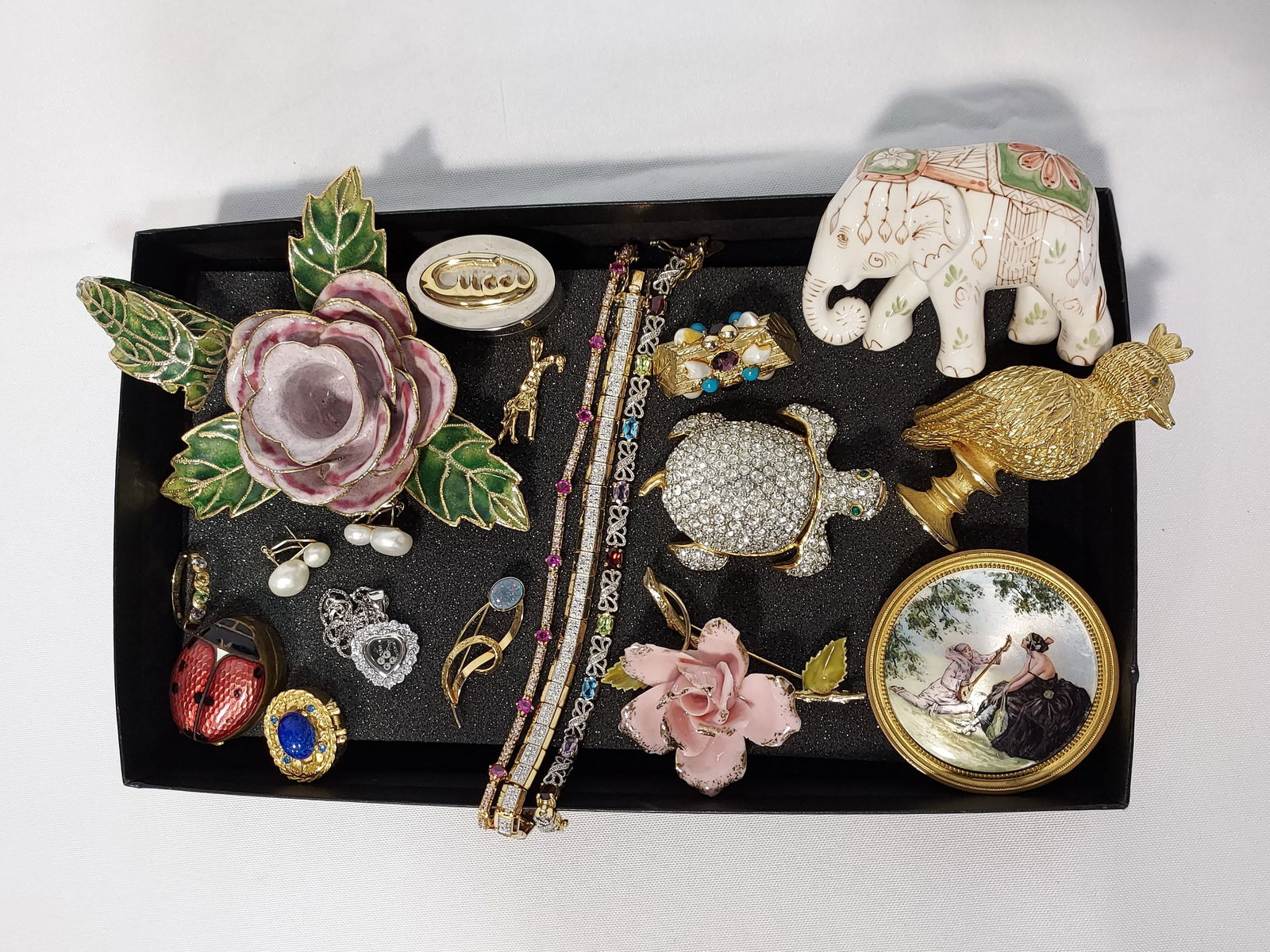 STERLING GEMS, GUCCI PILL BOX, PERFUME COMPACTS: Tray lot with enameled rose chamber candle stick, figural standing bird perfume compact, Gucci silver and gold plated pill box, three rhinestone sterling silver bracelets - 2 with semiprecious gems, a