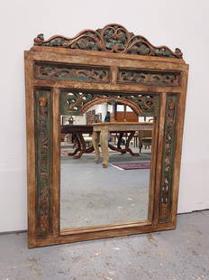 VINTAGE INDONESIAN CARVED WOOD WALL MIRROR 2 of 2: Vintage Indonesian carved wood wall mirror measuring 45.5" tall x 35.25" wide and 1" thick. Antiqued polychrome finish. Condition: intentional wear to finish, no repairs losses, see images. Weight: 30